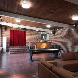 A room with sofas, table and a microphone for karaoke.