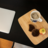Laptop, teacup and snacks on a table.