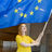 happy student holding an EU flag