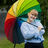 AYY Board's vice chair 2025 Elina Ståhlberg smiling and holding a rainbow colored umbrella