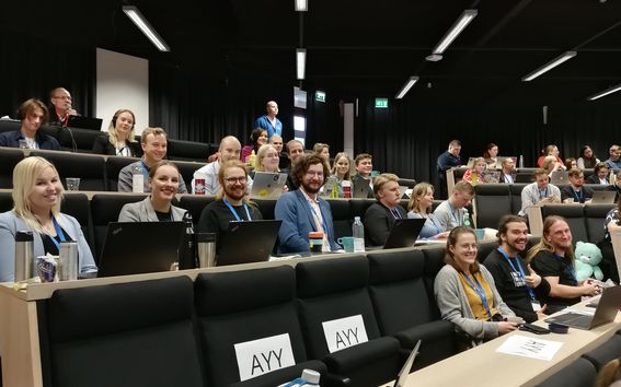 People in a meeting looking at the camera, smiling. 
