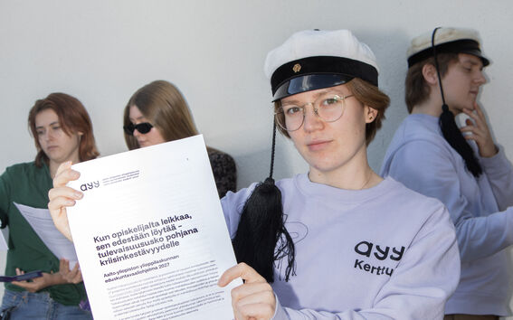 Students holding the parliamentary election programs