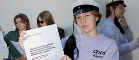 Students holding the parliamentary election programs