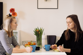 Friends having a coffee over a table.