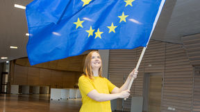 happy student holding an EU flag