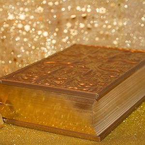 A bible surrounded by golden dust