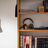 A lamp and a bookshelf with books and headphones.