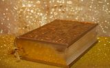 A bible surrounded by golden dust